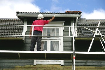 Image showing Man painting a house