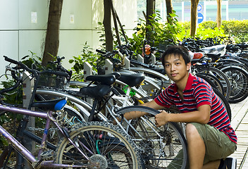 Image showing asia boy fix his bike