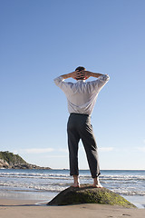 Image showing Businessman relaxing on a beach