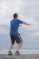 Image showing Mature runner doing squats