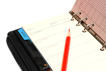 Image showing open black organizer and red pencil