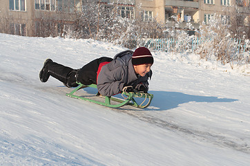 Image showing happy asian boy on sledge
