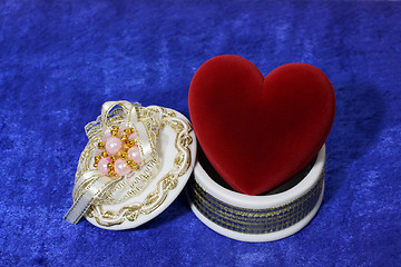 Image showing red heart in open box on blue velvet