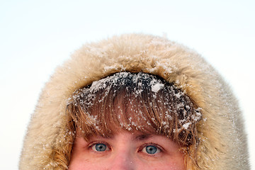 Image showing woman's blue eyes and hair under snow