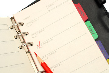 Image showing open organizer and red pencil