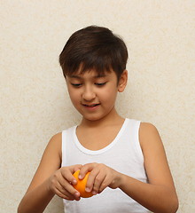 Image showing boy, peeling the orange