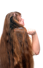 Image showing women combing her beautiful long red hair