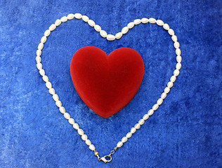 Image showing red heart and pearly neacklace on blue velvet