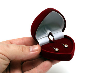 Image showing man's hand gifting ear-rings in red box