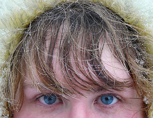 Image showing woman's blue eyes and hair under snow