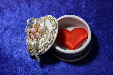 Image showing red heart in open box on blue velvet