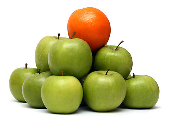 Image showing domination concepts - orange on pyramyd of apples