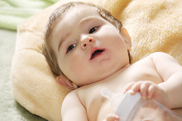 Image showing Serene baby with bottle closeup