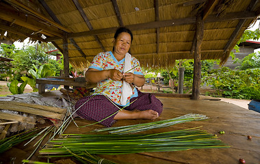 Image showing asian woman making straw mats