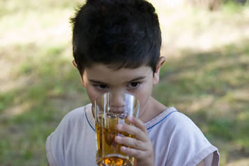 Image showing Boy drink juice