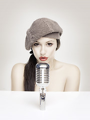Image showing Sexy woman singing in retro mic