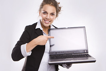 Image showing pretty businesswoman holding laptop