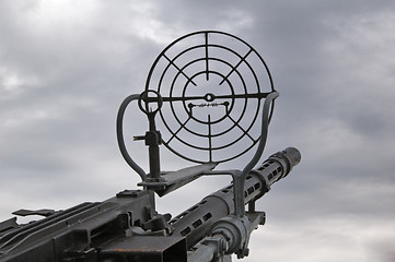 Image showing Kind on the sky through a machine gun sight 