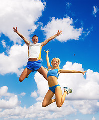 Image showing The sportsmans in a jump against the sky