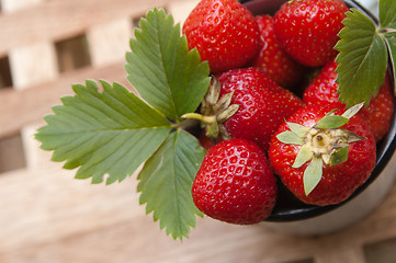 Image showing Strawberry in a mug on a table