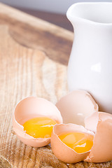 Image showing brown eggs and some milk