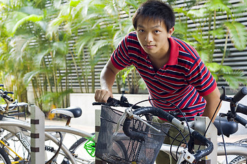 Image showing asia man take bike in bicyle park