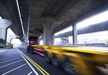 Image showing container car fast moving under the freeway bridge