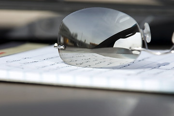 Image showing Close up on the Glasses and the Notepad