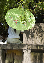 Image showing Tongli: lonely lady under umbrella caught in romantic thought.