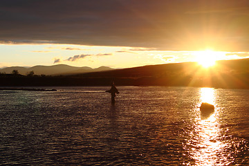 Image showing Fisherman in beautiful sunset scenery