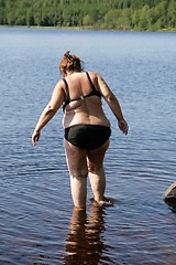 Image showing Overweight woman taking a bath