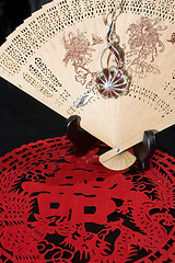 Image showing jewelry hitch on bamboo fan and paper-cut