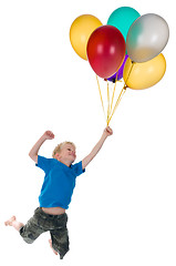 Image showing Boy Flying Behind Balloons