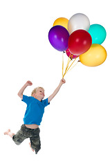 Image showing Boy Flying Behind Balloons