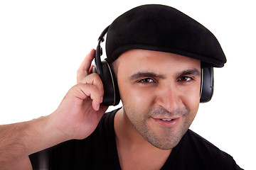 Image showing man listening music in headphones and smiling