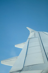 Image showing Wing of airplane against a blue sky