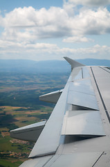 Image showing Wing of airplane going to land