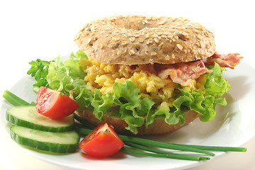 Image showing Bagel with scrambled eggs and bacon