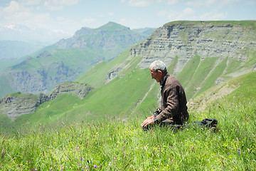 Image showing Man praying in mountains closeup