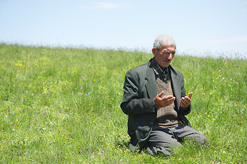 Image showing Man lifting hands in prayer