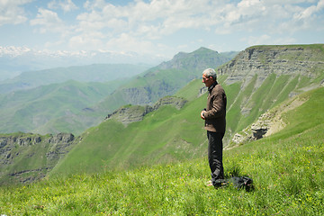 Image showing Man praying in mountains