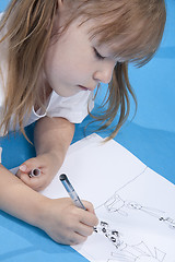 Image showing Small cute girl is sketching