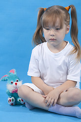 Image showing Small cute girl is posing on blue background