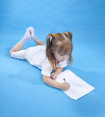 Image showing Small cute girl is sketching