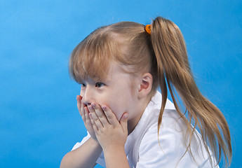 Image showing Small cute girl is covering one's face with one's hands isolated