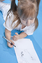 Image showing Small cute girl is sketching