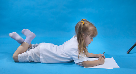 Image showing Small cute girl is sketching