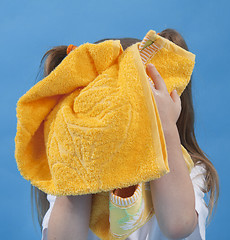 Image showing Small girl is wiping its face by towel isolated