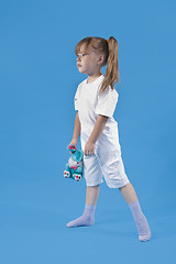 Image showing Small cute girl is posing on blue background