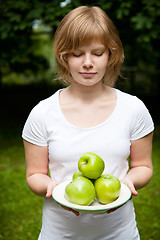 Image showing Girl holding fresh green apples